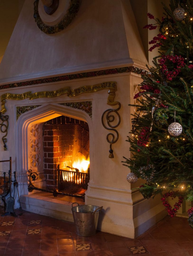 Christmas Tree Next To Fireplace With Fire